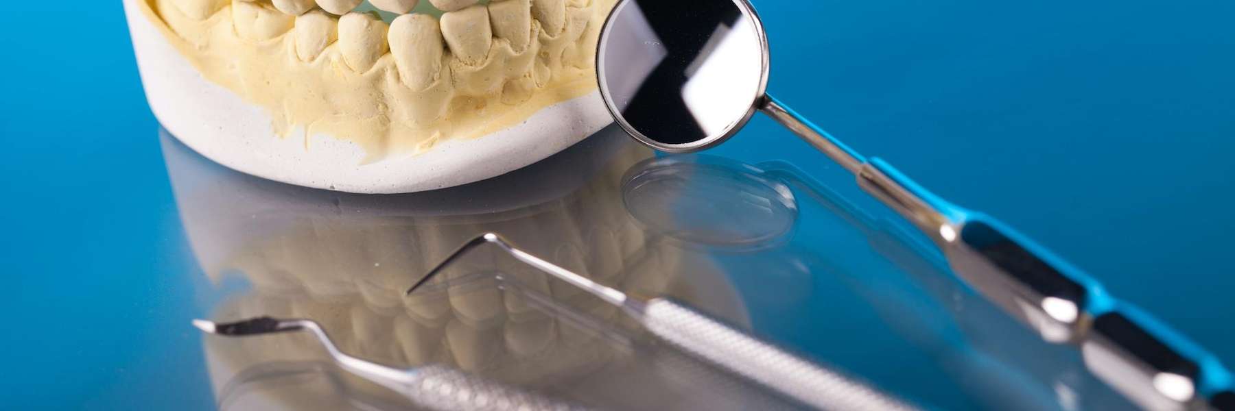 A picture of teeth extraction tools and a tooth in Middletown, NJ